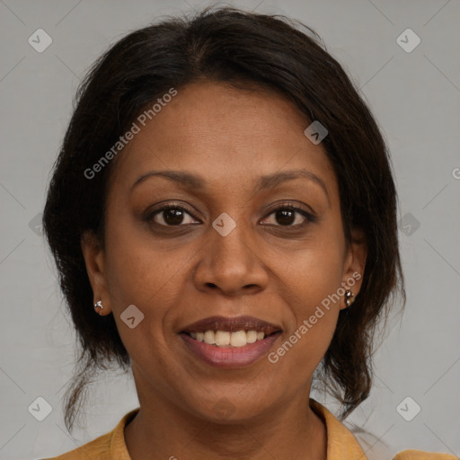Joyful black adult female with medium  brown hair and brown eyes