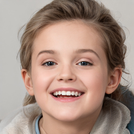 Joyful white child female with medium  brown hair and blue eyes