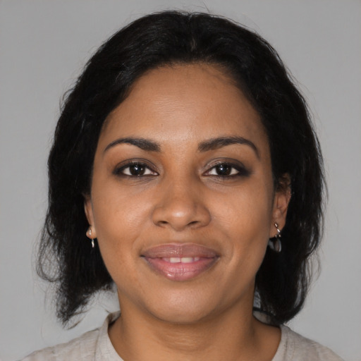 Joyful black young-adult female with medium  black hair and brown eyes