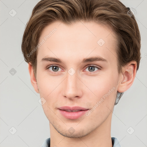 Joyful white young-adult male with short  brown hair and grey eyes