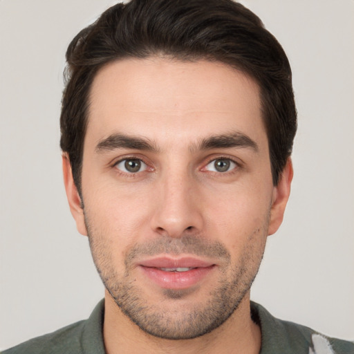 Joyful white young-adult male with short  brown hair and brown eyes