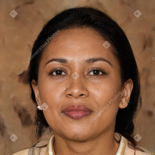 Joyful latino adult female with medium  brown hair and brown eyes