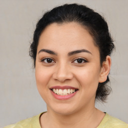 Joyful latino young-adult female with medium  brown hair and brown eyes