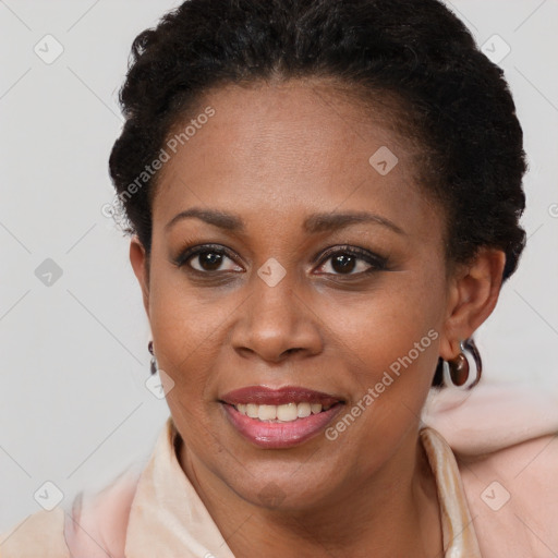 Joyful black young-adult female with short  brown hair and brown eyes