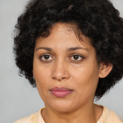 Joyful latino adult female with short  brown hair and brown eyes
