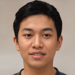 Joyful asian young-adult male with short  black hair and brown eyes