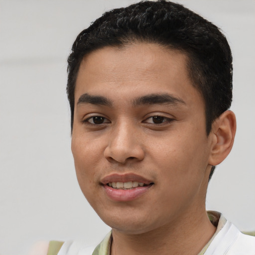 Joyful latino young-adult male with short  black hair and brown eyes