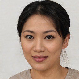 Joyful asian young-adult female with medium  brown hair and brown eyes