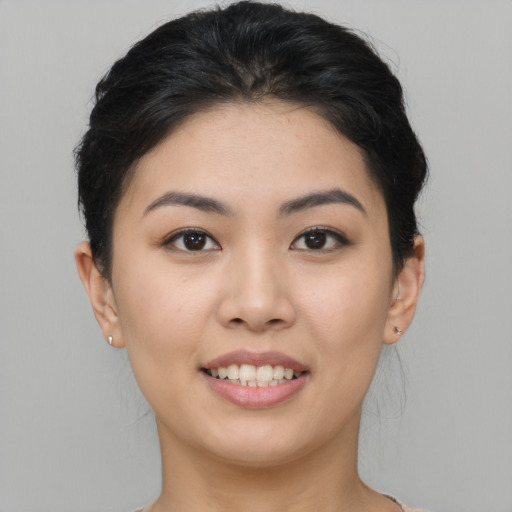Joyful asian young-adult female with short  brown hair and brown eyes