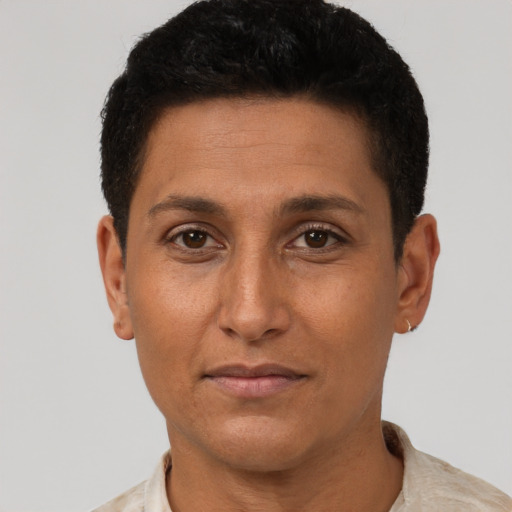 Joyful latino adult male with short  brown hair and brown eyes