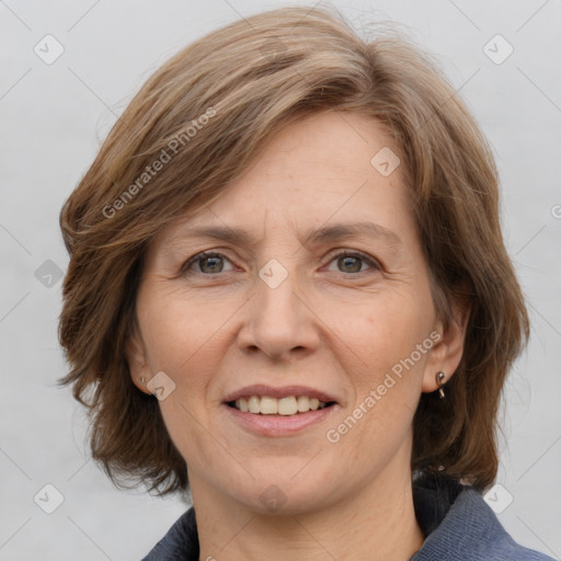 Joyful white adult female with medium  brown hair and grey eyes