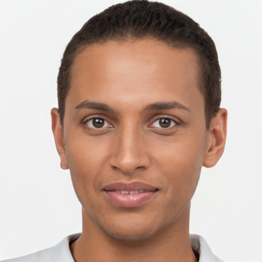 Joyful latino young-adult male with short  brown hair and brown eyes