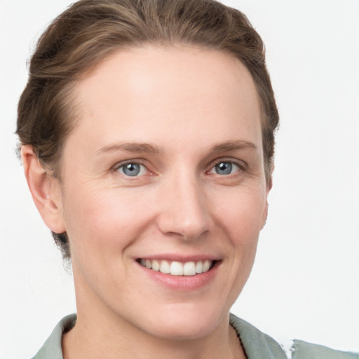 Joyful white young-adult female with short  brown hair and grey eyes