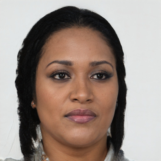 Joyful black young-adult female with long  brown hair and brown eyes