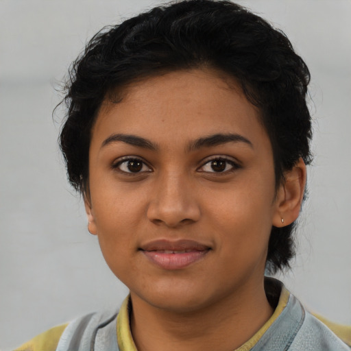 Joyful latino young-adult female with short  black hair and brown eyes