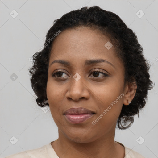 Joyful black young-adult female with medium  black hair and brown eyes