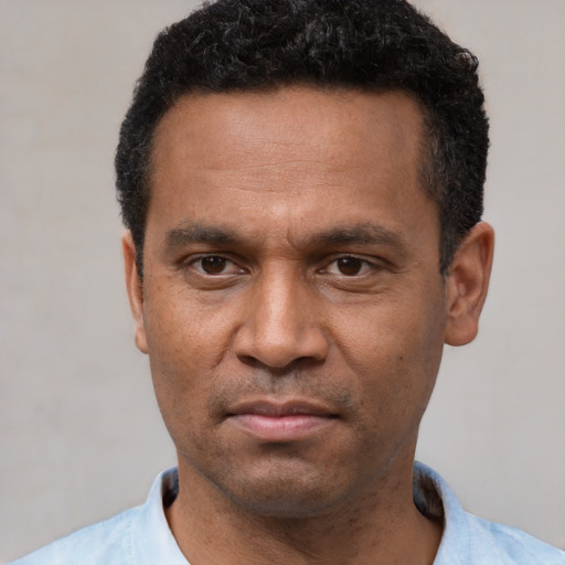 Neutral latino adult male with short  black hair and brown eyes
