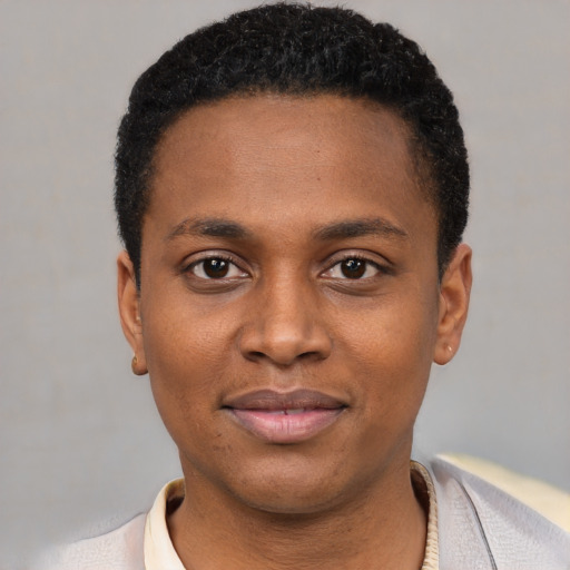 Joyful black young-adult male with short  black hair and brown eyes