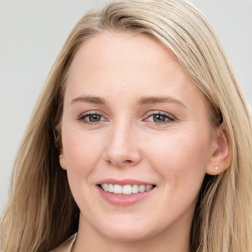 Joyful white young-adult female with long  brown hair and blue eyes