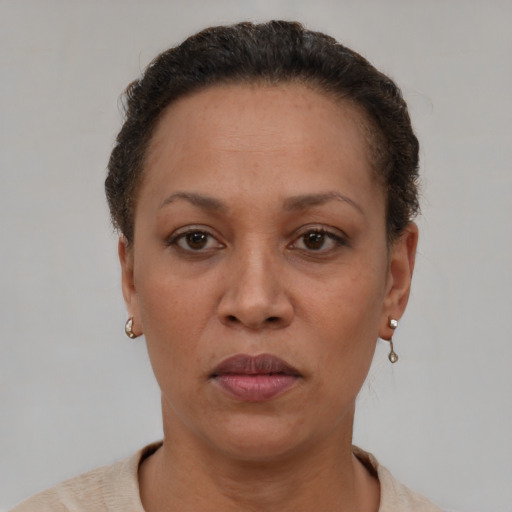Neutral latino adult female with short  brown hair and brown eyes