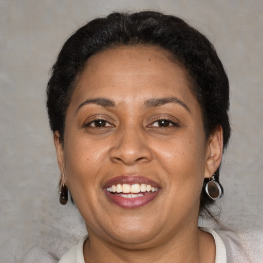 Joyful latino adult female with short  brown hair and brown eyes
