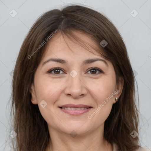 Joyful white adult female with long  brown hair and grey eyes