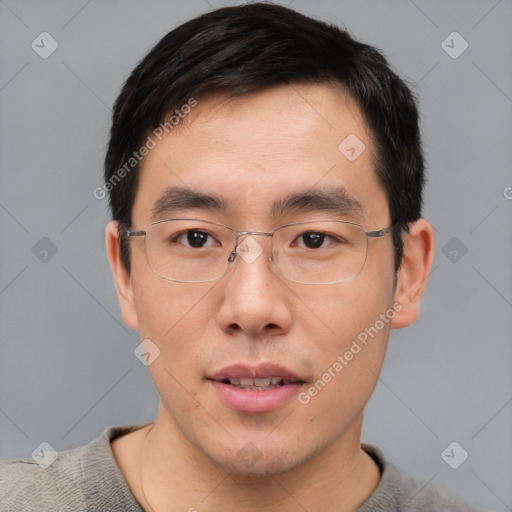 Joyful asian young-adult male with short  brown hair and brown eyes