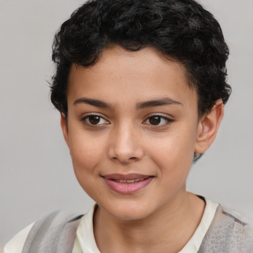 Joyful latino child female with short  brown hair and brown eyes