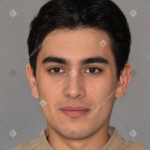 Joyful latino young-adult male with short  brown hair and brown eyes