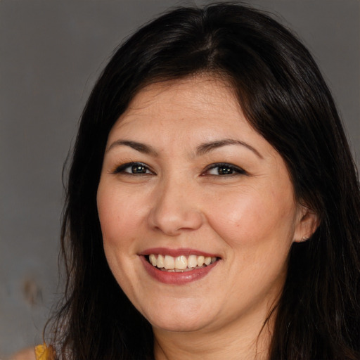 Joyful white adult female with long  brown hair and brown eyes