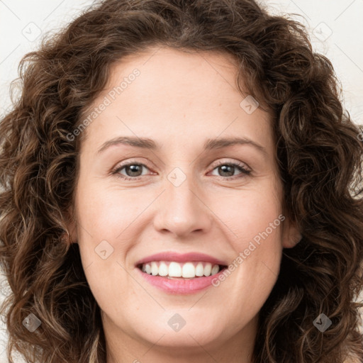 Joyful white young-adult female with long  brown hair and green eyes