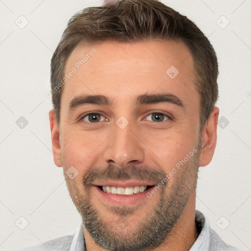 Joyful white young-adult male with short  brown hair and brown eyes