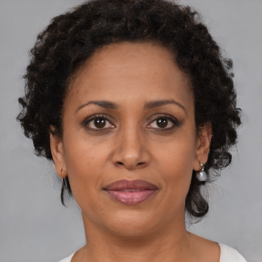 Joyful black adult female with medium  brown hair and brown eyes