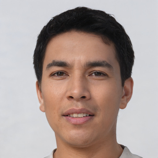 Joyful asian young-adult male with short  black hair and brown eyes