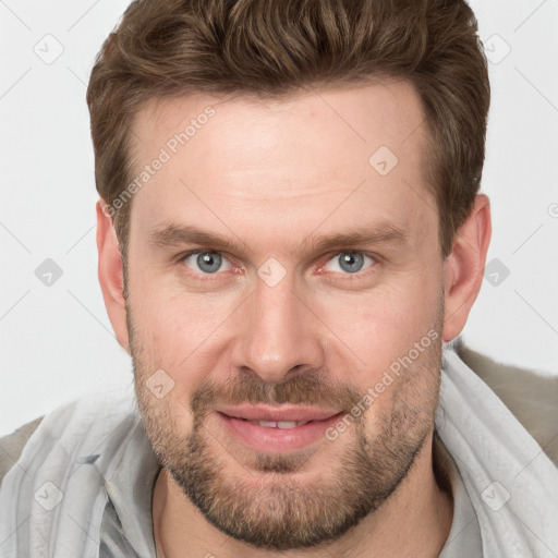 Joyful white adult male with short  brown hair and grey eyes