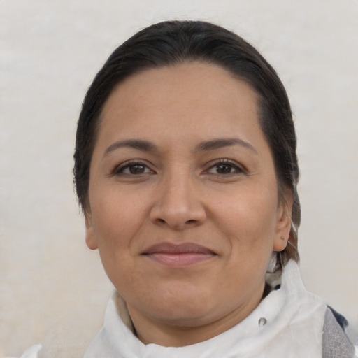 Joyful latino adult female with short  brown hair and brown eyes