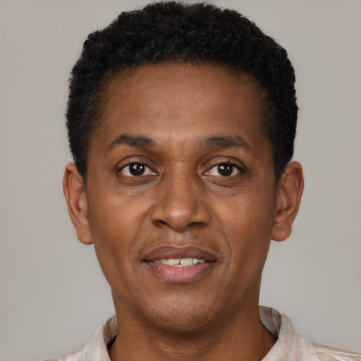Joyful latino young-adult male with short  brown hair and brown eyes