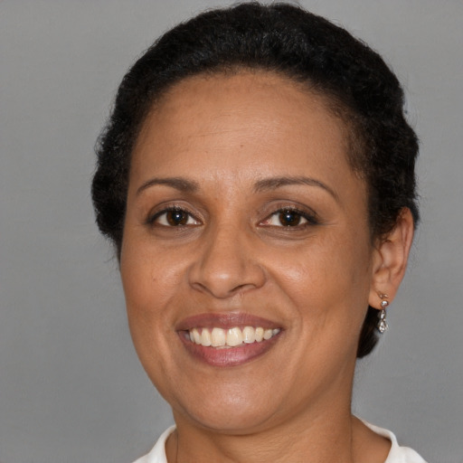 Joyful latino adult female with short  brown hair and brown eyes