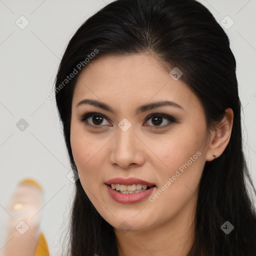 Joyful latino young-adult female with long  brown hair and brown eyes