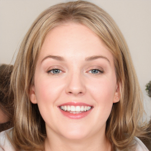 Joyful white young-adult female with medium  brown hair and blue eyes