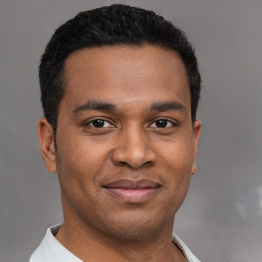 Joyful latino young-adult male with short  black hair and brown eyes