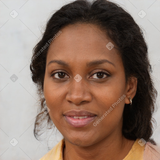 Joyful black adult female with medium  brown hair and brown eyes