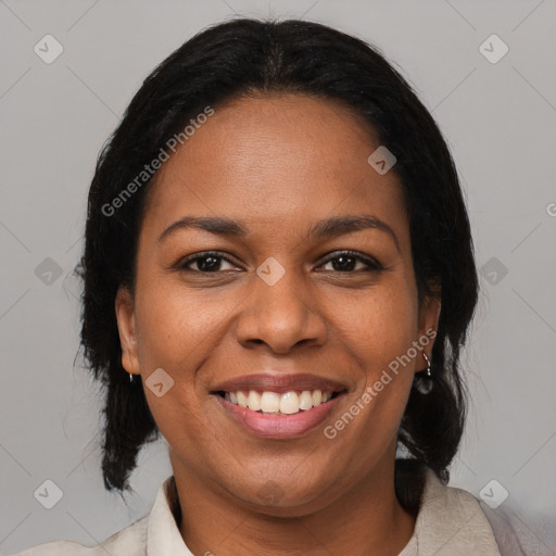 Joyful black adult female with medium  brown hair and brown eyes