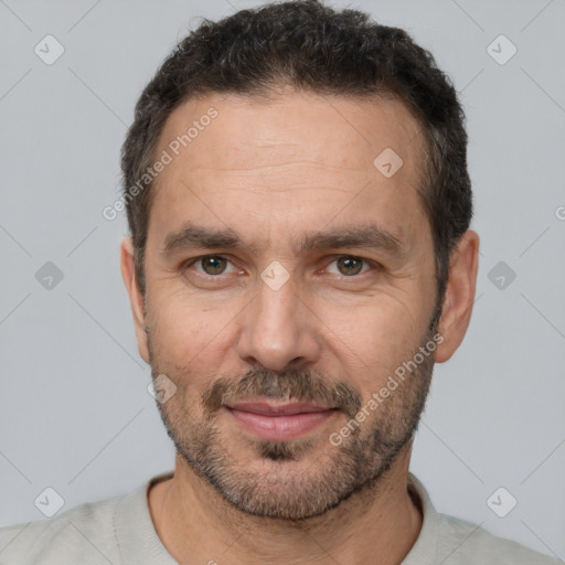 Joyful white adult male with short  black hair and brown eyes