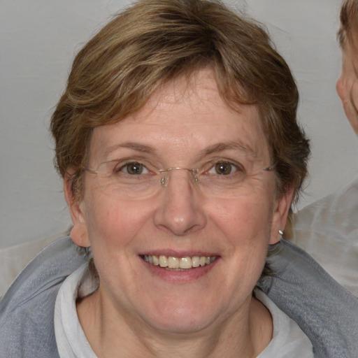 Joyful white adult female with medium  brown hair and blue eyes