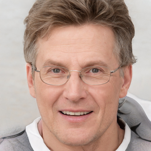 Joyful white middle-aged male with short  brown hair and blue eyes