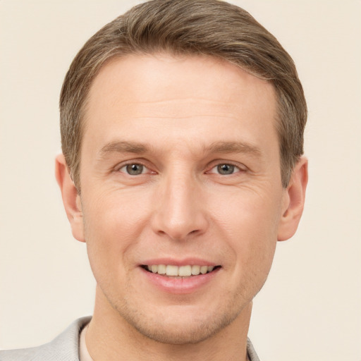 Joyful white adult male with short  brown hair and brown eyes