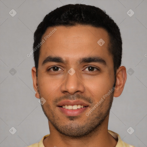 Joyful latino young-adult male with short  black hair and brown eyes