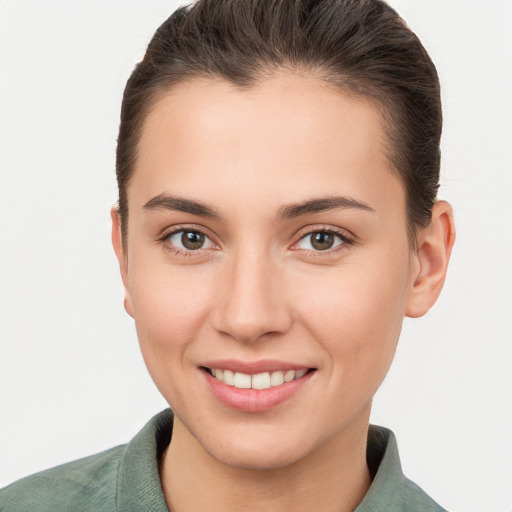 Joyful white young-adult female with short  brown hair and brown eyes