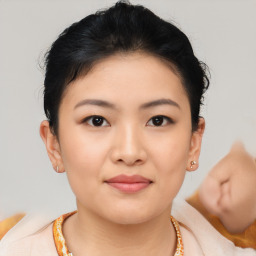 Joyful asian young-adult female with short  brown hair and brown eyes